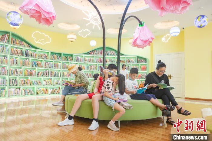 在江西省南昌市高新区图书馆的儿童阅读区内，不少儿童在阅读图书。　刘力鑫 摄